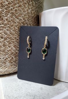 So elegant, but simple enough to be worn any day. These extremely lightweight earrings feature a beautiful emerald green glass bezel charm and a cubic zirconia paved huggie hoop. Even more beautiful in person! Total length is just over 3cm. ❤️ Handmade with love ❤️ Great for gifting Every item is handmade by me, so please understand there are no two items exactly alike. All jewelry may vary slightly from how they are pictured, but I try my best to take accurate pictures and make them all the same. Most metals will tarnish eventually, but there are things you can do to keep your jewelry looking great for as long as possible. Avoid spraying with perfumes or wearing in the shower. Storing your earrings in the plastic bag they arrive in will slow down the tarnishing process and keep them looki