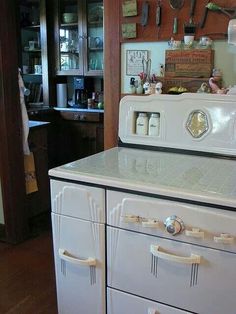 an old fashioned white stove in a kitchen