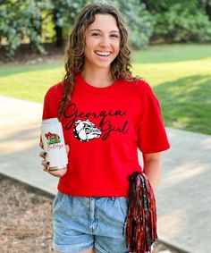 Show your state and team pride with this adorable Georgia Girl Shirt! From tailgating to football parties this will be your go to shirt this season! Super cute paired with shorts, jeans, or white skinny jeans!   * 6.0 oz., pre-shrunk 100% cotton* Double-needle stitched neckline and sleeves* Quarter-turned* Seamless seven-eighths inch collar* Taped neck and shoulders* Satin label* Rib cuffs Casual Tops With Team Name For Tailgating, White Casual Top For Tailgating, Casual White Top For Tailgating, Short Sleeve Sports Fan Tops For Tailgating, Sports Fan Short Sleeve Top For Tailgating, School Spirit T-shirt For Game Day In Spring, School Spirit Tops For Summer Cheerleading, Summer Cheerleading Tops With School Spirit Style, Summer School Spirit Tops For Cheerleading