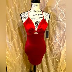 a mannequin with a red dress on display