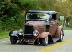 an antique car is parked on the side of the road