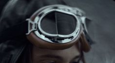 a woman with goggles on her head is looking at something in the camera lens