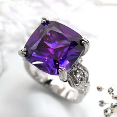 This beautiful Simulated Amethyst Ring, Sterling Silver Statement Ring for Women, Cushion Cut 10.5 Carat Vintage Cocktail Ring, Edwardian Engagement Ring by DoubleAccent is meticulously crafted in gleaming and durable Sterling Silver. Our stones are the highest quality diamond simulant that are polished, finely cut, loupe clean, and have an exactly similar appearance and as beautiful as to naturally occurring diamonds. All cubic zirconia stone weights are approximate and listed as diamond equiva Cushion Cut Amethyst Jewelry Gift, Purple Cushion Cut Jewelry Gift, Purple Cushion Cut Fine Jewelry, Purple Diamond Ring With Gemstone Accents For Anniversary, Formal Amethyst Rings With Vs Clarity, Formal Amethyst Ring With Vs Clarity, Formal Purple Sapphire Ring With Gemstone Accents, Purple Cubic Zirconia Birthstone Ring Gift, Formal Purple Diamond Birthstone Ring