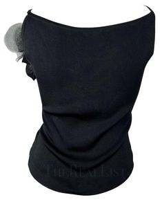 For Sale on 1stDibs - TheRealList presents: a fabulous black knit Yves Saint Laurent tank top. From the 1990s, this top features a scoop neckline, spaghetti straps, and a large Fitted Knit Party Tops, Fitted Knit Tops For Party, Black Fine Knit Top For Evening, Black Fitted Knit Top For Evening, Fitted Black Knit Top For Evening, Fitted Knit Top For Evening, Black Knit Tops For Evening, The 1990s, Floral Applique