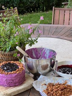 there are two cakes on the table and one is blueberry crumbler cake