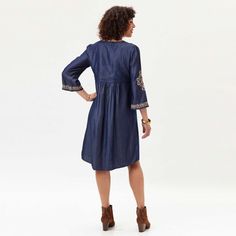 A lightly shaped denim dress with a flattering ballet neckline, shell-buttoned front, and 3/4 inch flared sleeves. Cool and relaxed, in sustainable Tencel that is finished with embroidery adds the perfect touch for a look that is both casual and sophisticated. Knee-length. Machine washable for easy care and convenience. Travels beautifully! Casual Embroidered Dress With 3/4 Sleeves, Denim Long Sleeve Dress With Floral Embroidery, Long Sleeve Denim Dress With Floral Embroidery, Tencel Dress, Tencel Denim, Delicate Embroidery, Embroidered Neckline, Flared Sleeves, Denim Dress