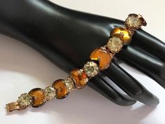 247.80 USD ❘❘❙❙❚❚ ON SALE ❚❚❙❙❘❘ Hi and 1950s 1960s collectible rhinestone bracelet in excellent vintage condition. Measures 7 1/4 inches long by three-quarter inches wide. Truly a fine example of the quality of the mid century collectible jewelry. Vintage Round Crystal Bracelet For Gift, Vintage Crystal Bracelet Gift, Vintage Formal Bracelets With Sparkling Stones, Vintage Bracelets With Sparkling Stones For Formal Occasions, Vintage Gold Crystal Bracelet As Gift, Vintage Crystal Bangle Bracelet Gift, Vintage Gold Crystal Bracelet As A Gift, Vintage Crystal Bracelet With Jewels As A Gift, Vintage Jeweled Bracelets For Party