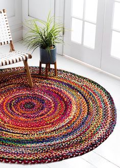 a multicolored rug with a chair and potted plant