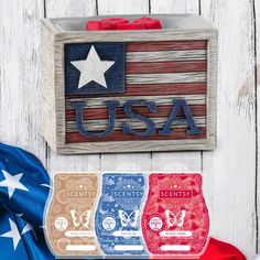 an american flag made out of wood with the word usa on it and three different colored wax