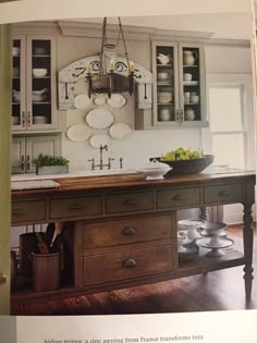 an old fashioned kitchen is featured in this magazine