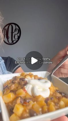 a woman is holding a bowl of food