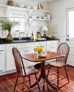 a kitchen with white cabinets and wooden flooring is featured in the magazine's cookbook