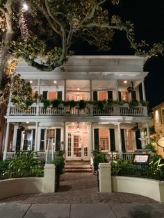 a large white house with lots of windows and balconies