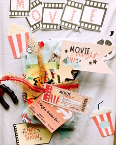 various movie themed items on a sheet of paper with scissors and tags attached to them