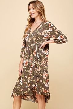 Faux wrap dresses are comfortable, stylish, and worry-free, with a flattering look, and this one is stunning. The gorgeous floral pattern and comfortable material is perfect for Fall. The bottom hemline is ruffled and there is an elastic band around the waist. Style with heels for a wedding. Model is 5'10" and wearing her true size Small. Small: Bust 16", Length 42.5" 95% Polyester, 5% Spandex Spring Flowy Faux Wrap Maxi Dress, Flowy Faux Wrap Dress For Spring, Flowy Wrap Dress With Floral Print For Vacation, Flowy Floral Print Wrap Dress For Brunch, Floral Print Wrap Dress For Vacation, Floral Print Wrap Dress For Beach, Floral Wrap Dress For Beach, Floral Print Wrap Dress With Surplice Neckline For Fall, Flowy Floral Dress With Surplice Neckline