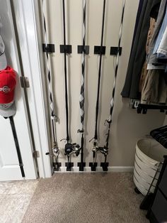 there are many skis and poles hanging on the wall in front of the door