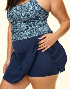 The Lotus High Rise Active Skort is the perfect mix of sporty and feminine. This skirt features built-in 2 ½" inseam moisture-wicking compression shorts for support and coverage while you move and pleats for a little extra flair. This skort will keep you comfortable and stylish all day long. (Available in plus-sizes 1X - 4X.) Casual Fitted Bottoms With Built-in Padding, Fitted Tennis Skirt With Built-in Shorts For Workout, Stretch Tennis Skirt With Wide Waistband For Workout, Fitted Swim Skirt With Built-in Shorts For Sports, Functional Fitted Athletic Shorts With Short Inseam, Fitted Blue Skort For Workout, Fitted Yoga Activewear With Short Inseam, Fitted Sports Activewear Shorts, Stretch Workout Skort With Wide Waistband