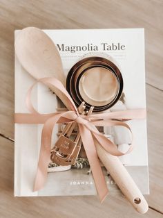 a wooden spoon sitting on top of a book