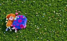 two clowns laying in the grass with confetti all over their backs and feet