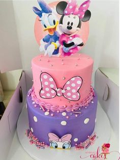 a cake with minnie mouse and mickey mouse on top