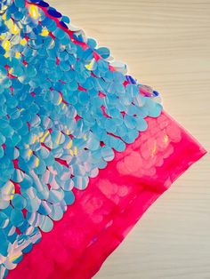 a pink and blue kite with lots of bubbles on it