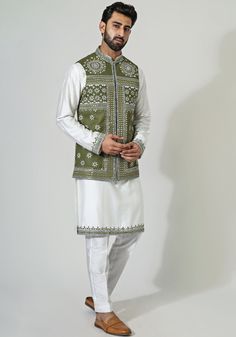 Featuring a stylish green cotton silk nehru jacket, intricately enriched with mirror and thread embroidery. Complemented by an off-white mirror work embellished cotton silk kurta and coordinating pants. A perfect choice for setting the stage on fire at any sangeet celebration.Composition : Nehru, Kurta and Pants - Cotton SilkCare: Dry Clean Only and Vacuum Storage This product can be customized for sleeves, length of blouse and neckline Delivery : 3-4 weeks as the product is hand crafted. Check Size Guide or choose MySize for free customisation (All Sizes above XL can be made at 15% additional cost) For more information and sizes please contact fabiliciousfashion@gmail.com or visit our Copenhagen studio. About the Designer : Chatenya Mittal started his career with a degree in Fashion from Kurta And Pants, Vacuum Storage, Nehru Jacket, Silk Kurta, White Mirror, Nehru Jackets, Pants Cotton, Thread Embroidery, Mirror Work