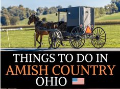 an amish country sign with a horse drawn carriage on the road and trees in the background