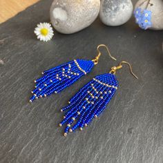 These earrings have a stunning deep and rich deep midnight blue colour and are absolutely stunning. A touch of elegance and luxury without breaking the bank. These are lightweight and would add a lovely dollop of shimmer and sparkle to enhance any outfit. These would be a perfect gift for a mum, sister, friend, girlfriend, wife. Material: Czech beads woven using durable thread. Technique: Brick stitch and fringe Ear wire: You can choose between ear hooks and clip-on fittings. I offer a choice of finishes including sterling silver 925, gold-plated, golden and silver-colour fittings to suit most needs.   Dimensions: The length stated includes the handmade beaded piece and brass component. For the drop length, add 1.2 - 1.6 cm (ear wire-dependent)  Packaging: Earrings will be wrapped in colou Party Blue Beaded Earrings With Gold Beads, Blue Long Drop Jewelry With Beaded Fringe, Blue Beaded Fringe Dangle Earrings, Blue Dangle Earrings With Beaded Fringe, Elegant Blue Tassel Earrings With Beaded Fringe, Blue Beaded Fringe Drop Earrings, Blue Beaded Fringe Tassel Earrings As Gift, Handmade Blue Tassel Earrings For Party, Blue Gold Beaded Drop Earrings