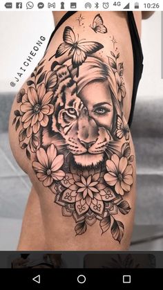 a woman's stomach with a tiger tattoo on it and flowers around her waist