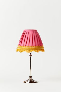 a pink and yellow lamp on a white background