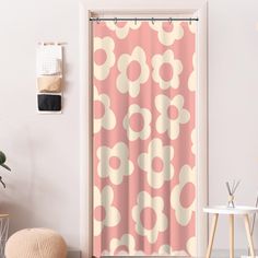 an open door with a pink and white shower curtain next to a potted plant