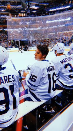 the hockey players are sitting on the bench