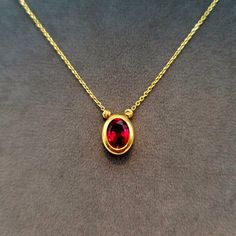 18K Solid Gold Diamond-cut Cubic Zirconia Charm Necklace, 18K Solid Gold Cable Chain, Oval Shape Red Stone Charm Necklace, Anniversary, Christmas Gift for Her/Mom! --- Created in GURANTEED HIGH QUALITY 18-Karat SOLID GOLD --- * More details: Total Gram weight: 3.80 gr Chain Length: 18.5 inches Chain Thickness: 1 millimeter Chain Style: Cable Closer: Spiring ring Pendant Height: 11 mm (millimeter) Pendant Width: 9 mm Stone: Red Cubic Zirconia This magnificent charm necklace secures with a spiring ring clasp. This perfect jewelry makes you become the center of attention! * 18K Solid Gold: 18k solid gold pieces are made to last forever. Solid 18K gold jewelry is the most expensive and high quality option as it doesn't rub off or flake, and doesn't tarnish. Solid gold actually increases in val Gold Oval Ruby Necklace, Oval Red Necklace For Anniversary, Red Oval Necklace For Anniversary, Oval Ruby Gold Necklace, Classic Red Oval Pendant Necklace, Precious Jewels, 18k Gold Jewelry, Gold Piece, Ring Pendant