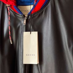 This Bomber Jacket Is Crafted In Black Gg Leather. Black Gg Leather; Washed And Wrinkled Lining; Front Pockets; Zip Closure; Made In Italy. Lining Is Blue Interior With A Red Hoodie. Colors Are Blue Red And Black. Gucci Black Outerwear For Streetwear, Gucci Designer Outerwear For Streetwear, Red Gucci Outerwear For Fall, Luxury Gucci Hooded Outerwear, Luxury Hooded Gucci Outerwear, Gucci Red Winter Outerwear, Red Gucci Winter Outerwear, Designer Gucci Hooded Outerwear, Gucci Coat