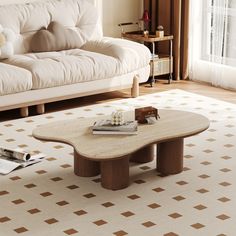 a coffee table sitting on top of a white rug in a living room next to a couch