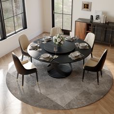 a round dining table with chairs around it