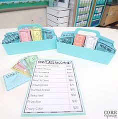 a table topped with blue boxes filled with cards and paper money sitting on top of it