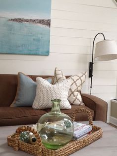 a living room filled with furniture and a painting on the wall above it's coffee table