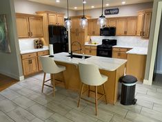 a kitchen with an island and two stools