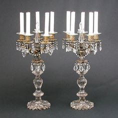 two crystal candelabras with candles on them