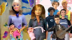 several barbie dolls are posed in front of a wall with images of people on it