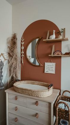 a baby crib in front of a mirror and shelves