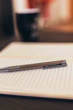 a pen sitting on top of an open notebook