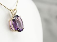 This amethyst gem is bursting with brilliant purple color! The oval cut faceting optimizes its luster, and the yellow gold only compliments the stone with its warm hue. This pendant could be worn everyday or for special occasions! This pendant does not come with the chain shown. Please feel free to contact us, we will help you find the perfect chain for your style and budget! Metal: 14K Yellow Gold Gem: Amethyst 14.00 Carats Gem Measurements: 17.7 x 14.5 mm, Oval Measurements: 26 x 15 mm, with b Luxury Amethyst Large Pendant Jewelry, Luxury Amethyst Oval Pendant Jewelry, Elegant Oval Purple Gemstones, Elegant Purple Oval Gemstones, Classic Oval Purple Gemstones, Purple Oval Classic Gemstones, Purple Oval Diamond Cut Jewelry, Oval Purple Diamond Cut Jewelry, Classic Purple Oval Gemstones