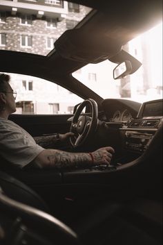 a man sitting in the driver's seat of a car