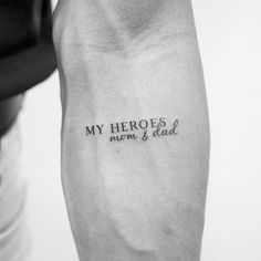 a man's arm with the words my hero is mom and dad written on it