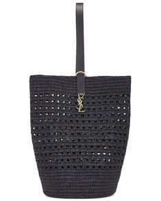 the saint laurent black woven tote bag is shown with gold hardware and leather handles