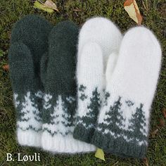 two white and green mittens laying on top of the grass next to each other