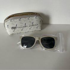 New With Tags. 1989 (Taylor's Version) Sunglasses And Pouch. Official Merch Purchased Directly From The Taylor Swift Online Store. Check Out My Closet For More Taylor Swift Items, Make An Offer, And Bundle For Discounts. Thanks For Looking! Casual Beige Rectangular Sunglasses, Classic White Sunglasses For Everyday Use, Classic White Sunglasses For Everyday, Trendy Wayfarer Sunglasses For Everyday Use, Casual Rectangular Sunglasses For Everyday Use, Vintage Beige Sunglasses For Summer, Casual Cream Sunglasses For Summer, Taylor Swift Accessories, 15 Taylor Swift