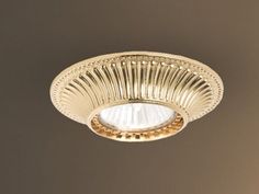 a light that is on the ceiling in a room with brown walls and flooring